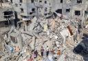 Palestinians look at the destruction after an Israeli airstrike in Rafah, Gaza Strip (Mohammad Jahjouh/AP)