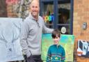 Makers Gallery Holt co-owner and artist John Frith and William Hall, 8, stand in front of their respective paintings