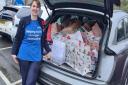 Julie Bailey from Tesco packing a car full of Christmas gifts.