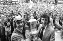 Ipswich Town captain Mick Mills with Roger Osborne, who scored the winning goal against Arsenal in the FA Cup final at Wembley in 1978. They hold aloft the trophy as they arrive at Ipswich Town Hall          Picture: PA