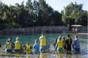 Children wait to swim with a dolphin during the Dreamflight visit to Discovery Cove in Orlando, Florida.