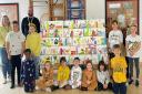 Staff and pupils at St Christopher's Primary School with the artwork donated by the anonymous artist.