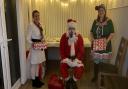 Staff at the refuge has made it as special as possible for the women and children. Left to right: Sarah Hart, child support worker, Father Christmas, Louise Pag, child support worker.