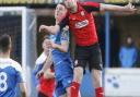 Bury Town debutant, Alex Henderson, on loan from Ipswich Town, challenges Coggeshall attacker Ross Wall to a high ball. Picture: PAUL VOLLER