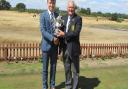 George Fricker of Ufford Park receives the Mackenzie Cup as Suffolk Junior champion from Suffolk Golf Union chairman Colin Firmin. Picture: BILL DARLING