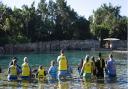 Children wait to swim with a dolphin during the Dreamflight visit to Discovery Cove in Orlando, Florida.