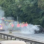 The A14 westbound is closed after a car caught fire