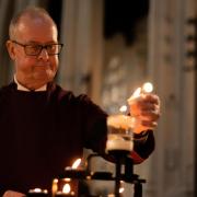 Members of the public visited Bury St Edmunds Cathedral to pay their respects to Her Majesty the Queen. Verger Alan O\'Connor lights a candle.