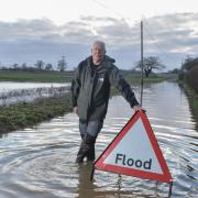 Blaxhall's flood warden Alistair Shaw amongst the flooding in Station Road outside his house.
