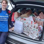 Julie Bailey from Tesco packing a car full of Christmas gifts.