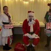 Staff at the refuge has made it as special as possible for the women and children. Left to right: Sarah Hart, child support worker, Father Christmas, Louise Pag, child support worker.