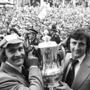 Ipswich Town captain Mick Mills with Roger Osborne, who scored the winning goal against Arsenal in the FA Cup final at Wembley in 1978. They hold aloft the trophy as they arrive at Ipswich Town Hall          Picture: PA