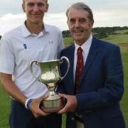 Gregor Tait receives the Seaton Robson Trophy from Aldeburgh club captain Antony Dearden. Photograph: TONY GARNETT