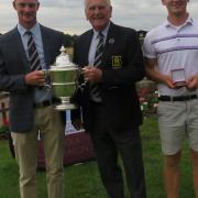 James Biggs presented with the Faraday Trophy by SGU president Colin Firmin. Liam Hansey of Bungay, the winner of the handicap prize, is on the right. Picture: TONY GARNETT