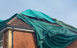A sheet covers the roof of the west Suffolk home after the blaze